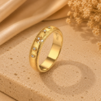 Close-up of the Stella 18K gold wedding band with delicate moissanite accents