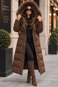 Elvara Long Puffer Coat in Brown with oversized fur-trimmed hood worn up