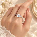Aurora Diamond Ring worn on hand showing the 1 carat round center diamond and zircon pavé band