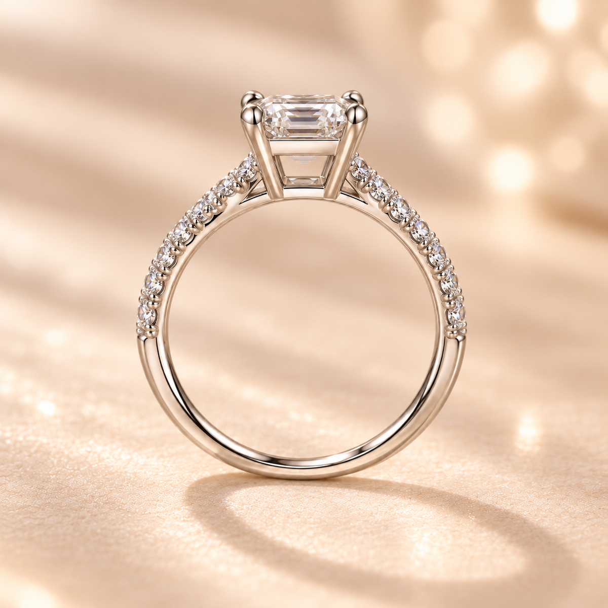Side profile of the Celestia Ring showing the raised basket and emerald-cut center stone