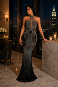 Maison Bragga Velora black crystal-embellished halter evening gown in a luxurious penthouse setting