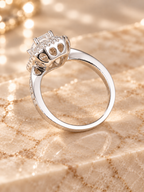 Three-quarter view of the Lumière Ring showing the emerald-cut center and double zircon halo