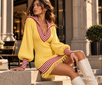 Rivelle Striped Knit Dress in Soft Yellow with red striped trim, styled in a luxury street setting