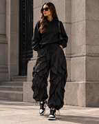 Maison Bragga Veyra parachute pants in Black styled with oversized hoodie and high-top sneakers