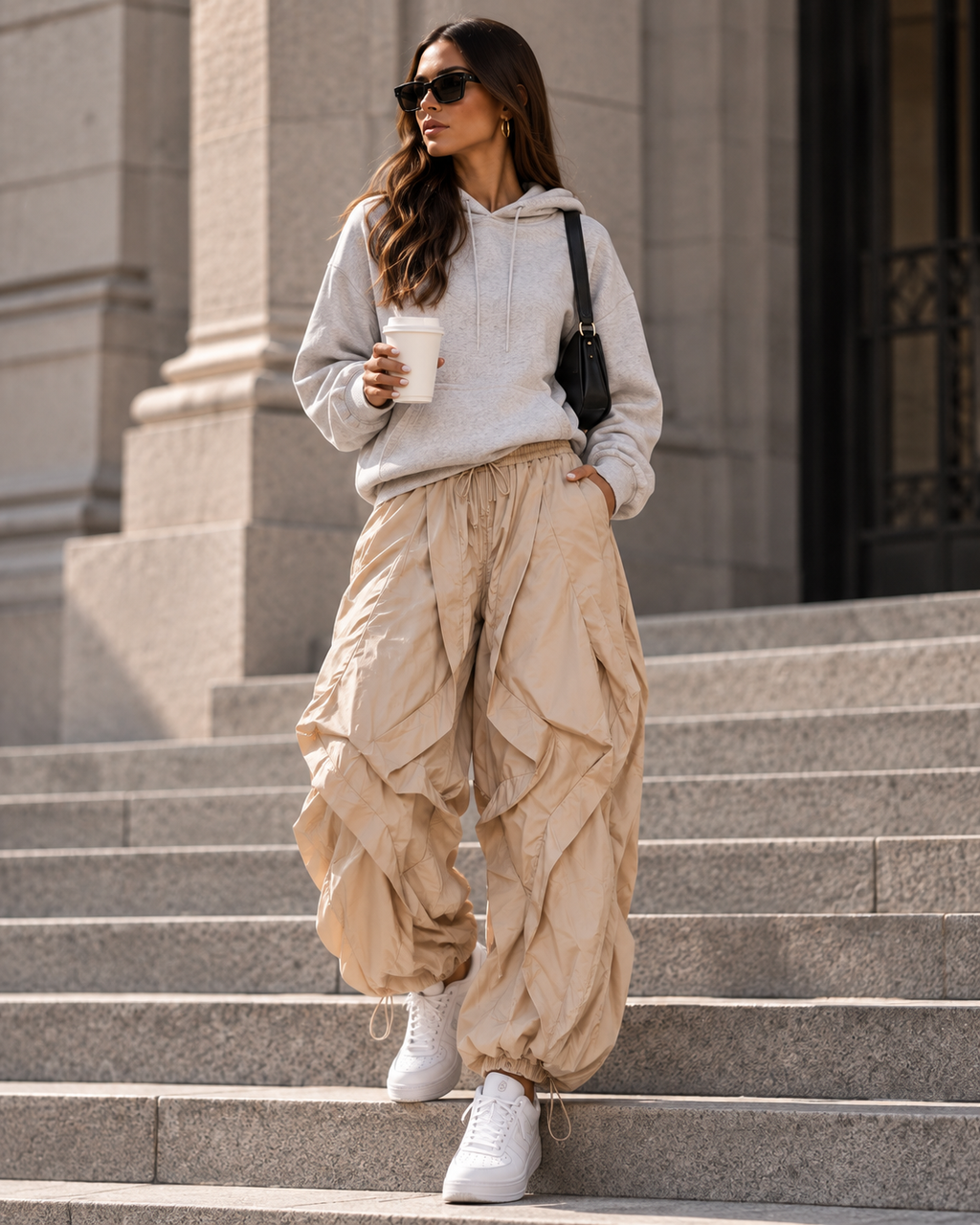 Maison Bragga Veyra parachute pants in Sand Beige styled with grey hoodie and white sneakers
