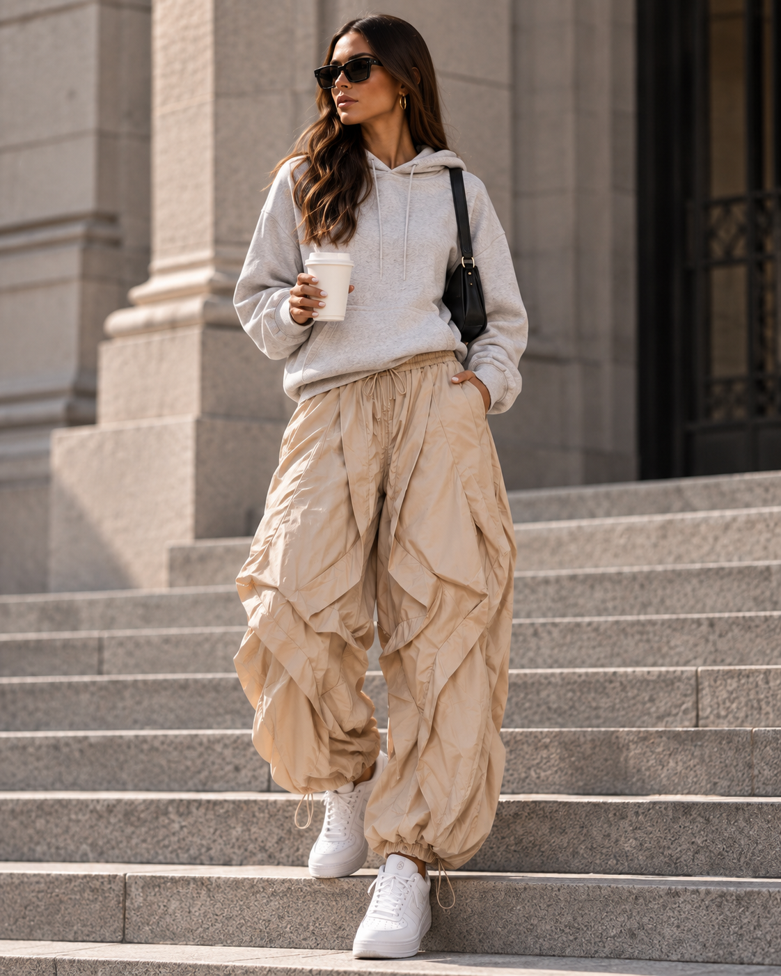 Maison Bragga Veyra parachute pants in Sand Beige styled with grey hoodie and white sneakers