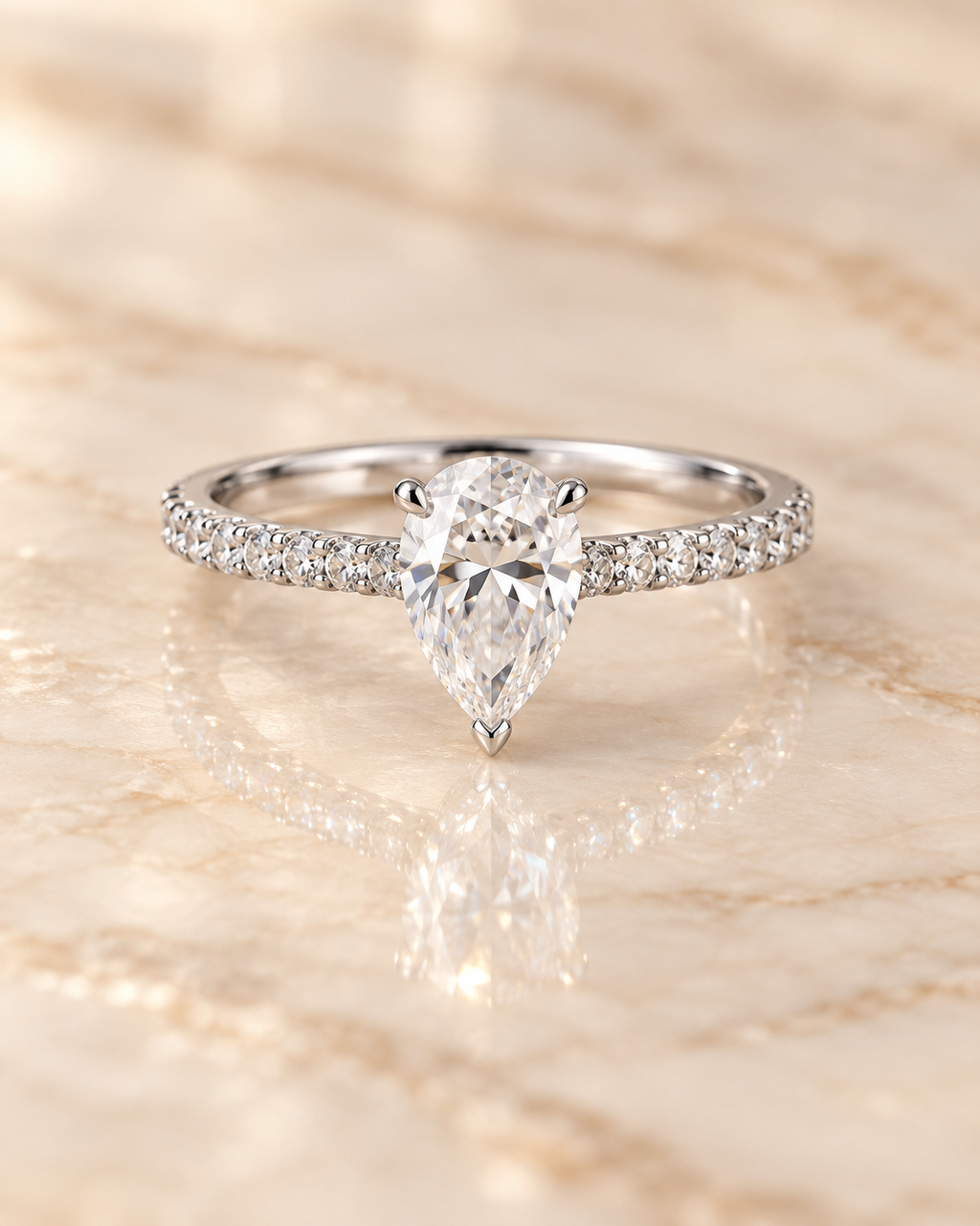 Front view of the Seraphine Diamond Ring with 1 carat pear-cut lab-grown diamond and zircon pavé shoulders