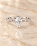 Front view of the Seraphine Diamond Ring with 1 carat pear-cut lab-grown diamond and zircon pavé shoulders
