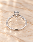 Profile view of the Seraphine Diamond Ring showing the raised pear-cut setting and pavé shoulders