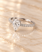 Three-quarter view of the Seraphine Diamond Ring showing the pear-cut center and pavé shoulders