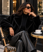 Velmora Jacket in Black styled at an elegant city cafe