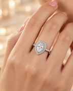 Versailles Ring worn on hand with pear-cut lab-grown diamond, double zircon halo and pavé band
